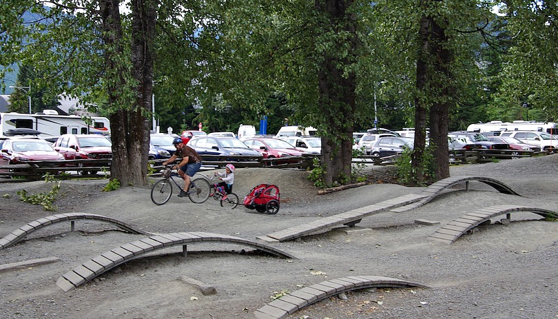 Father pulls daughter through Whistler dirt jump park