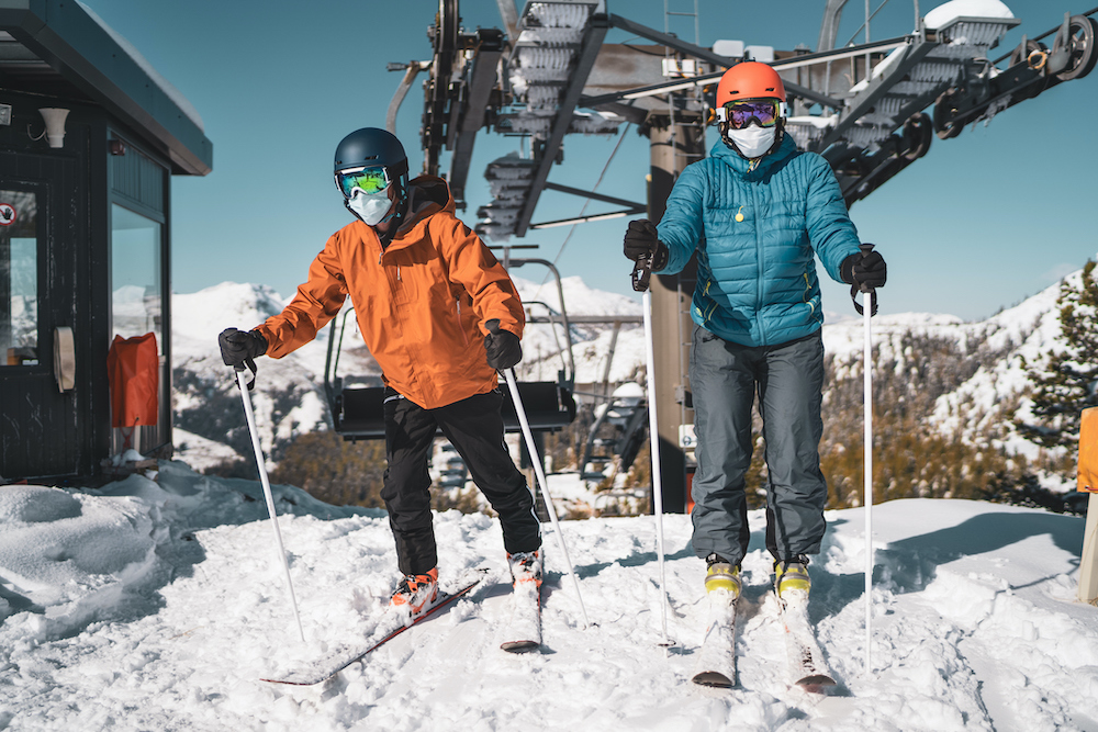Skiers wear masks as they get off the ski lift