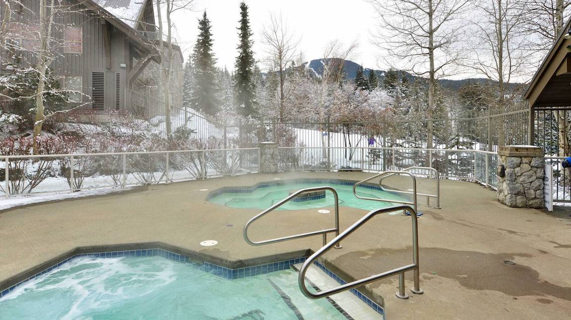 Hot tubs at The Aspens while the snow falls