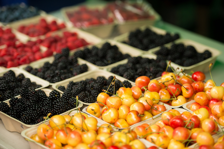 row of produce at market blackberries, raspberries, blueberries