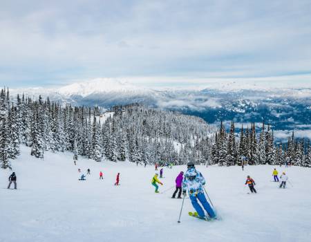 Colorful skiers on Whistler in the spring